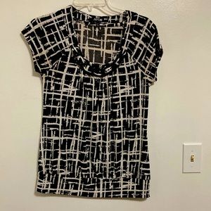 Black and white small blouse that fits more like a medium.